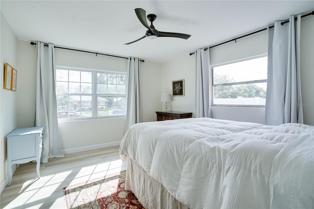 bedroom with light hardwood / wood-style floors and ceiling fan