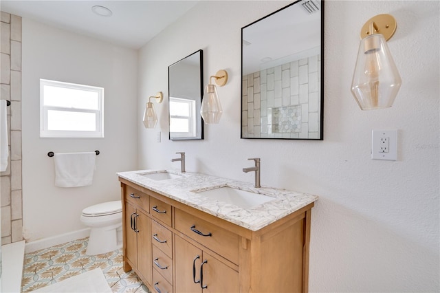 bathroom with vanity, tile patterned floors, and toilet