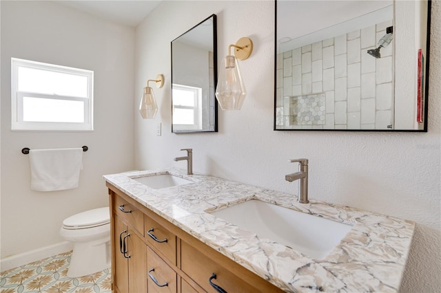 bathroom with tile patterned flooring, vanity, and toilet