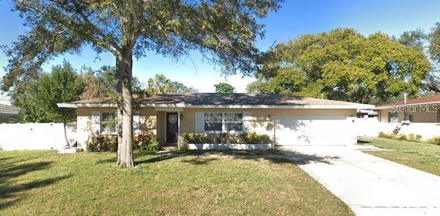 single story home with driveway, a garage, fence, and a front yard