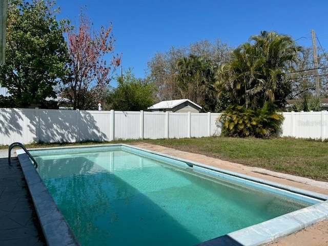 view of pool featuring a lawn, a fenced backyard, and a fenced in pool