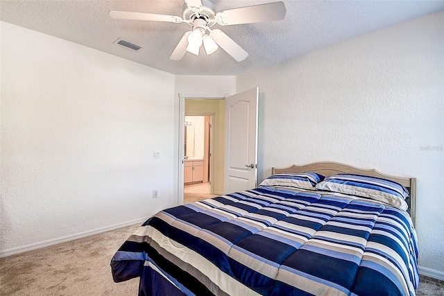 carpeted bedroom featuring a textured ceiling and ceiling fan