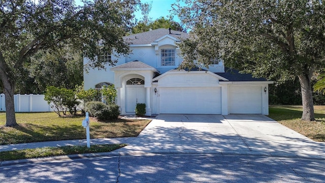 view of front facade featuring a front yard and a garage