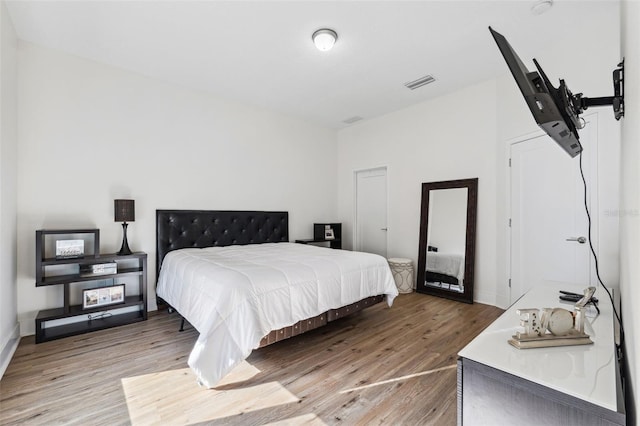 bedroom with wood-type flooring