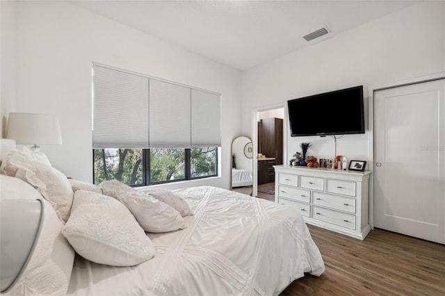 bedroom featuring dark hardwood / wood-style flooring and a closet