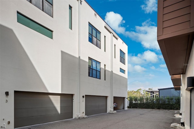 view of property exterior with a garage