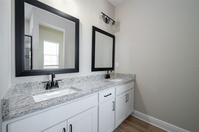 bathroom with hardwood / wood-style floors and vanity