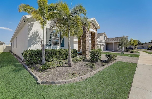 view of front facade with a front yard and a garage