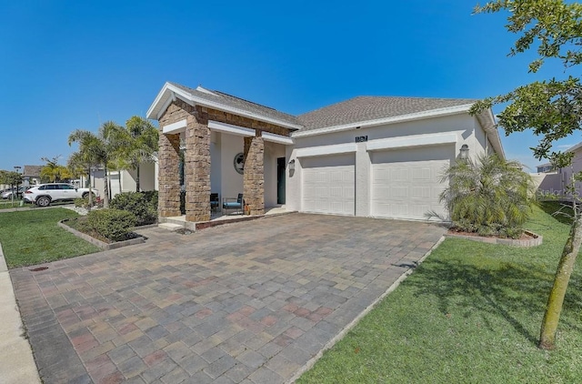 view of front of property featuring a front yard and a garage