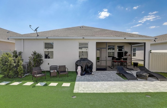 back of house with central air condition unit, a yard, and a patio