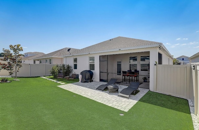 rear view of property with a yard and a patio