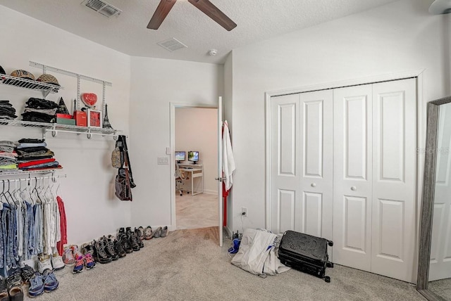 interior space with ceiling fan and light colored carpet