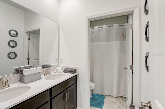 bathroom with tile patterned floors, vanity, a shower with shower curtain, and toilet