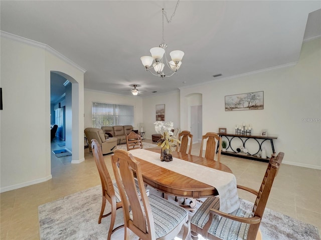 tiled dining room featuring ceiling fan with notable chandelier and ornamental molding