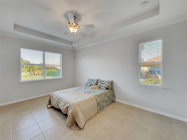 bedroom with a raised ceiling, ceiling fan, light tile patterned floors, and ornamental molding