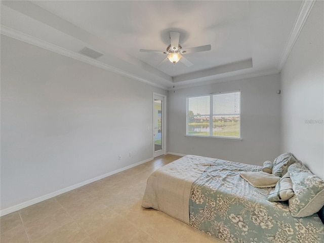 tiled bedroom with a tray ceiling, ceiling fan, and ornamental molding