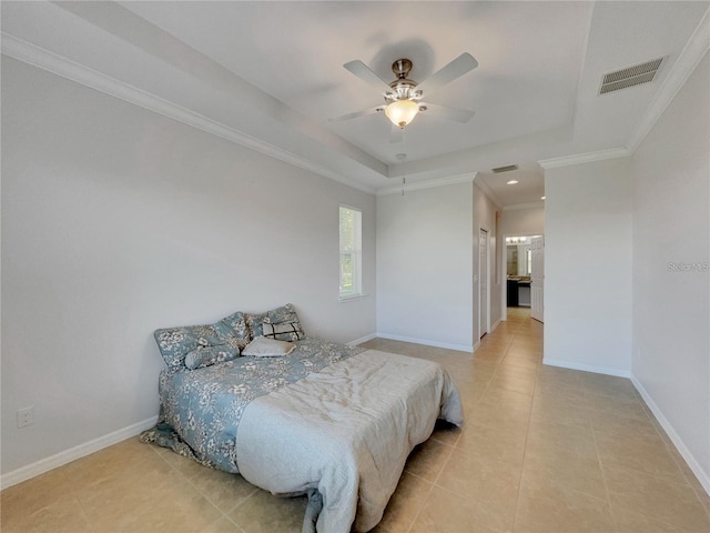 bedroom featuring ceiling fan, light tile patterned floors, crown molding, and a tray ceiling