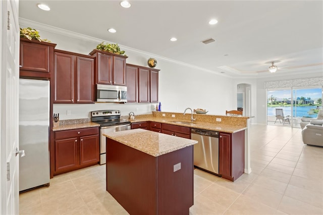 kitchen featuring ceiling fan, sink, light stone countertops, kitchen peninsula, and appliances with stainless steel finishes