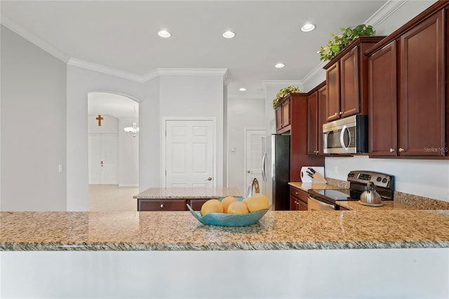 kitchen featuring kitchen peninsula, light stone countertops, stainless steel appliances, and ornamental molding