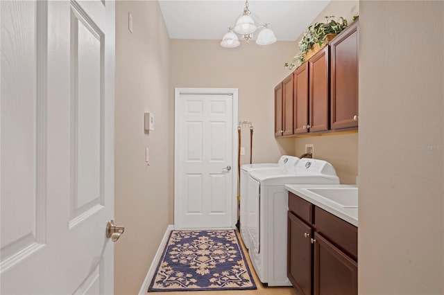 laundry room featuring cabinets, an inviting chandelier, sink, separate washer and dryer, and light tile patterned floors