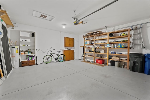 garage featuring water heater and a garage door opener