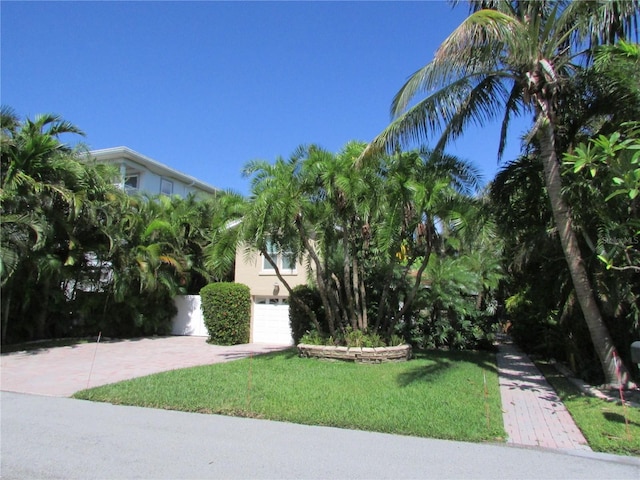 view of front of home featuring a garage and a front lawn