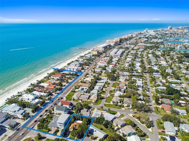 bird's eye view featuring a water view and a beach view