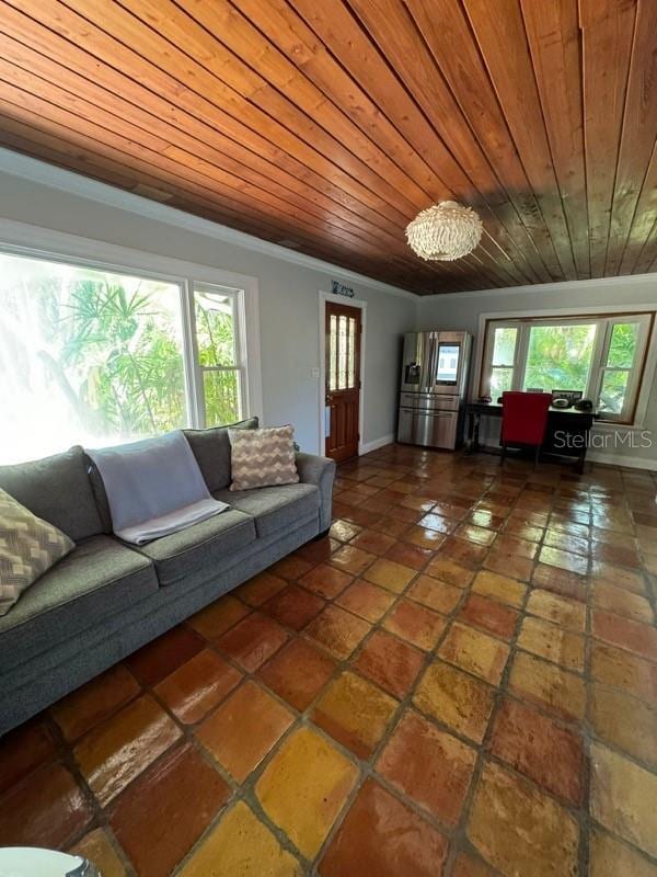 living room with wood ceiling, crown molding, and a healthy amount of sunlight