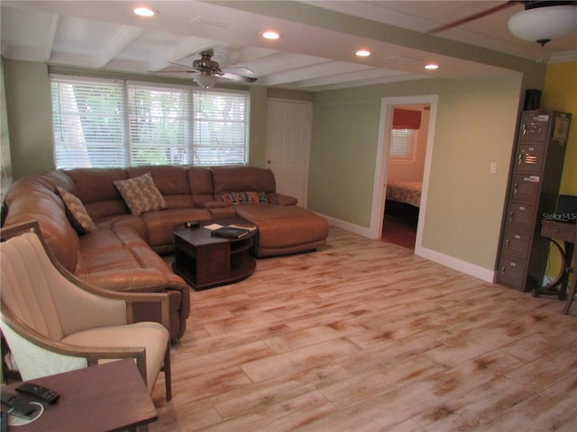 living room featuring beamed ceiling, ceiling fan, light hardwood / wood-style floors, and coffered ceiling