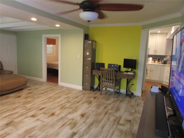 home office with ceiling fan, light hardwood / wood-style floors, and crown molding