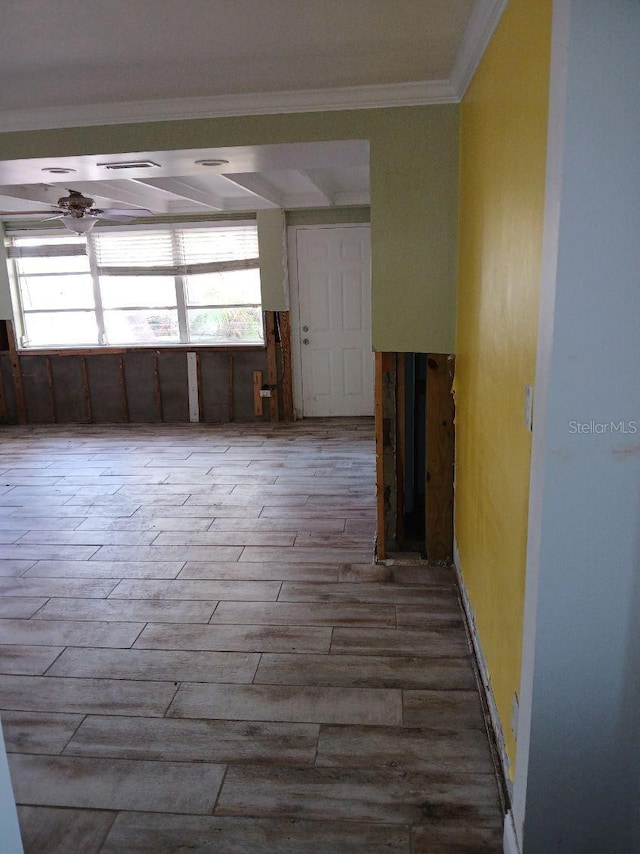 interior space with ornamental molding and hardwood / wood-style flooring