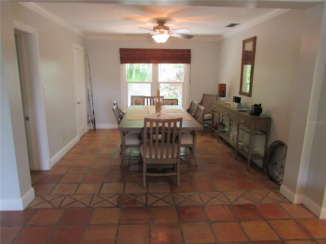 dining space with dark tile patterned flooring, ceiling fan, and crown molding