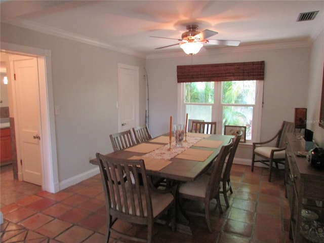 tiled dining room featuring ceiling fan and crown molding