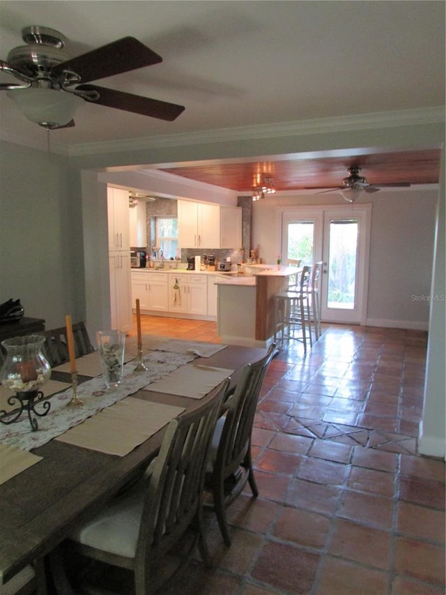 dining area featuring french doors, ceiling fan with notable chandelier, and ornamental molding