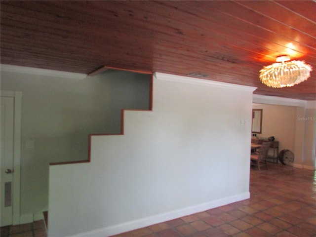 stairway with tile patterned floors and wood ceiling