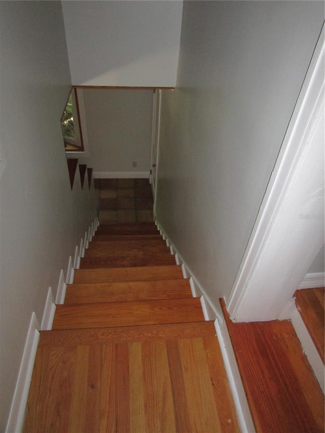 stairs with hardwood / wood-style floors