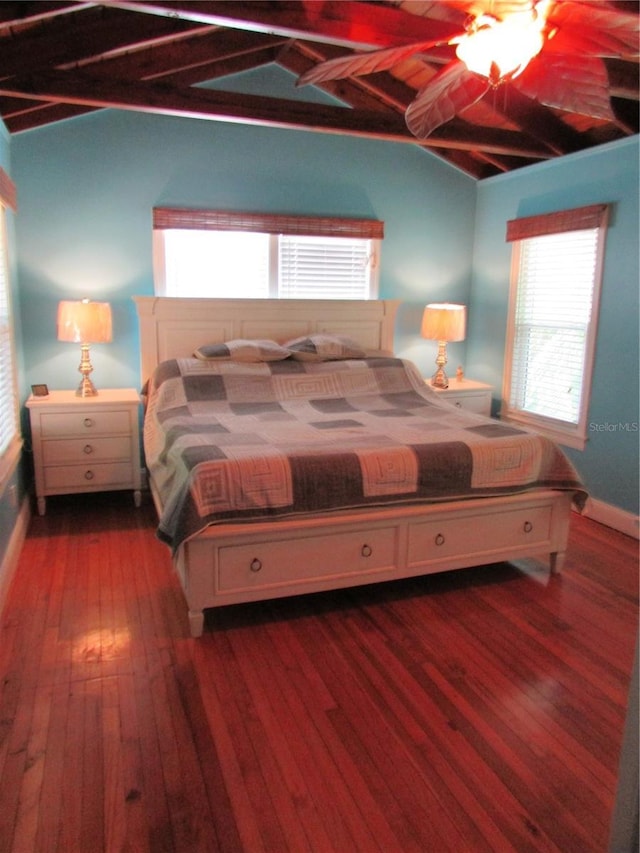 bedroom featuring vaulted ceiling with beams, ceiling fan, and dark wood-type flooring