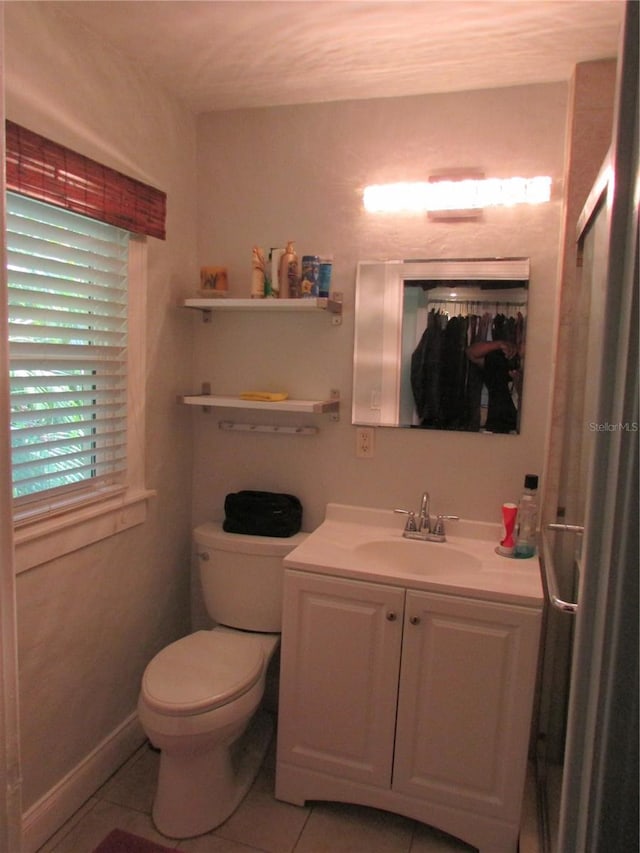 bathroom featuring tile patterned floors, vanity, and toilet