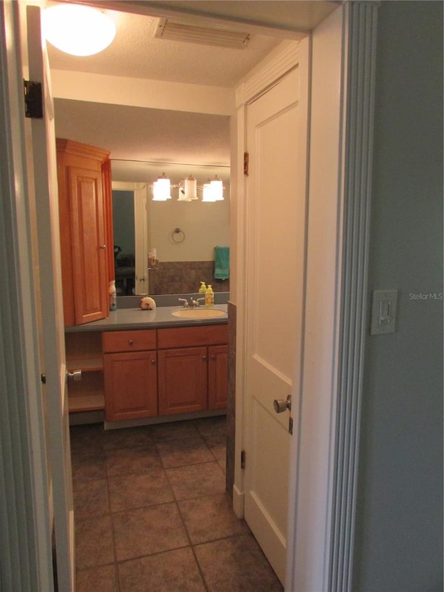 bathroom featuring tile patterned flooring and vanity