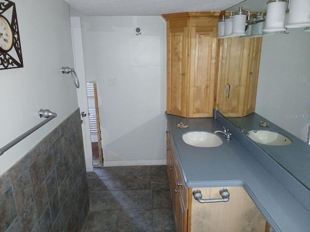 bathroom with tile patterned flooring and vanity