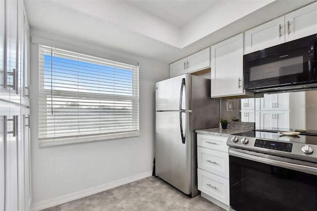 kitchen featuring light stone countertops, appliances with stainless steel finishes, and white cabinetry