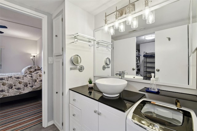 bathroom featuring vanity and washer / clothes dryer