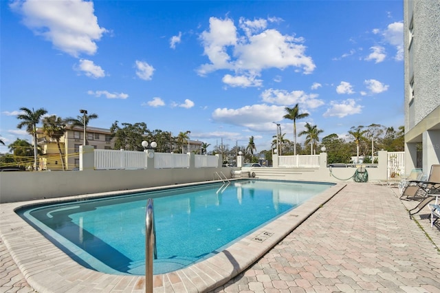 view of swimming pool with a patio