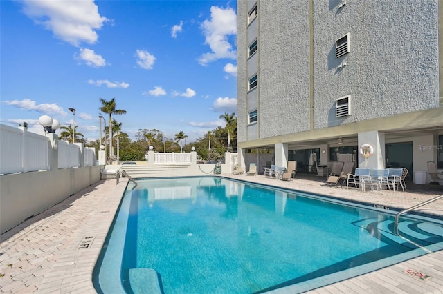 view of swimming pool featuring a patio area