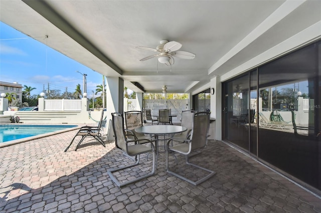 view of patio / terrace with ceiling fan and a fenced in pool