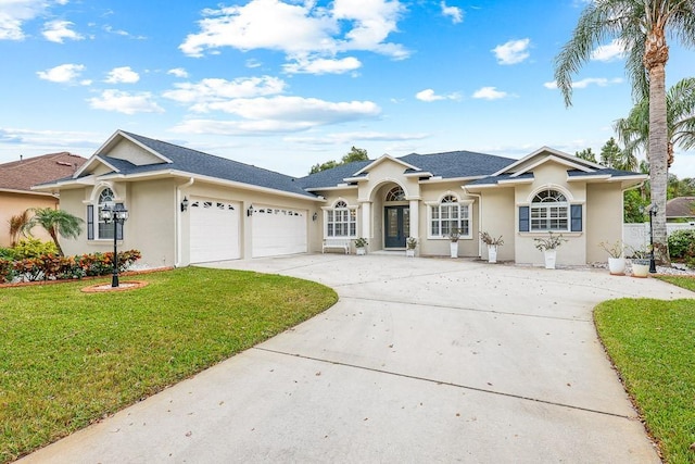 single story home featuring a garage and a front lawn