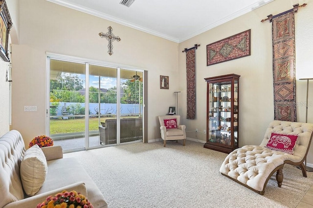 living area with carpet and ornamental molding