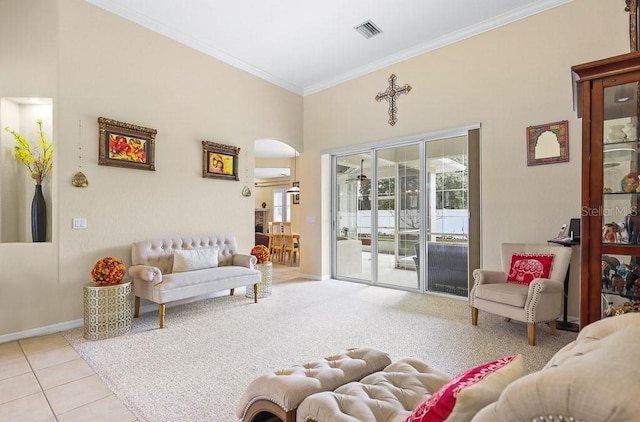 living room with ornamental molding and light tile patterned flooring