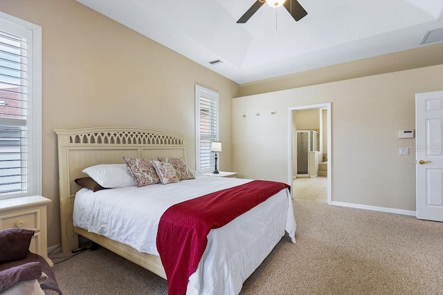 bedroom featuring connected bathroom, light colored carpet, and ceiling fan