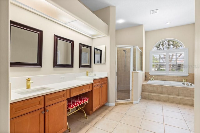 bathroom with tile patterned flooring, shower with separate bathtub, and vanity